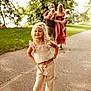 Isabella joined the competition — help win amazing prizes! child, family, outdoor, park, path, grass, trees, woman, man, baby, smile, sandals, dress, casual_clothing, nature, sunlight, portrait, happy, posing, blurred_background