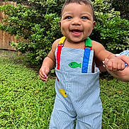 Amereond joined the competition — help win amazing prizes! baby, child, blue_eyes, dimples, overalls, colorful_clothing, grass, greenery, outdoor, smiling, happy, person, holding_hand, nature, bushes, fence, daylight, cute, portrait, standing
