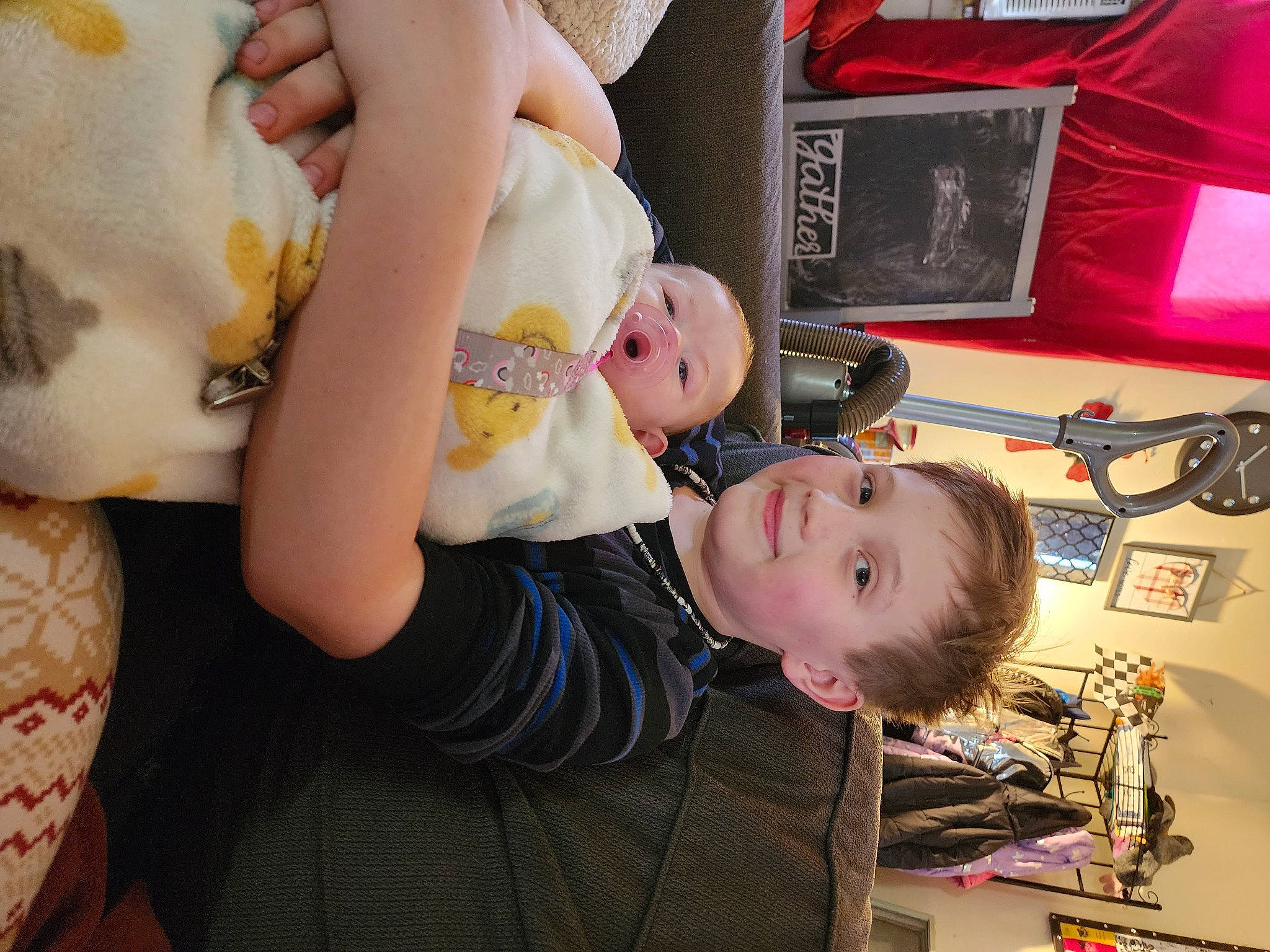 Adrien is registered to the contest to win money with this photo: arm, baby, baby_products, baby_toddler_clothing, cheek, child, fun, hairstyle, happy, joy, mouth, nail, organ, people, person, play, room, sitting, smile, t_shirt