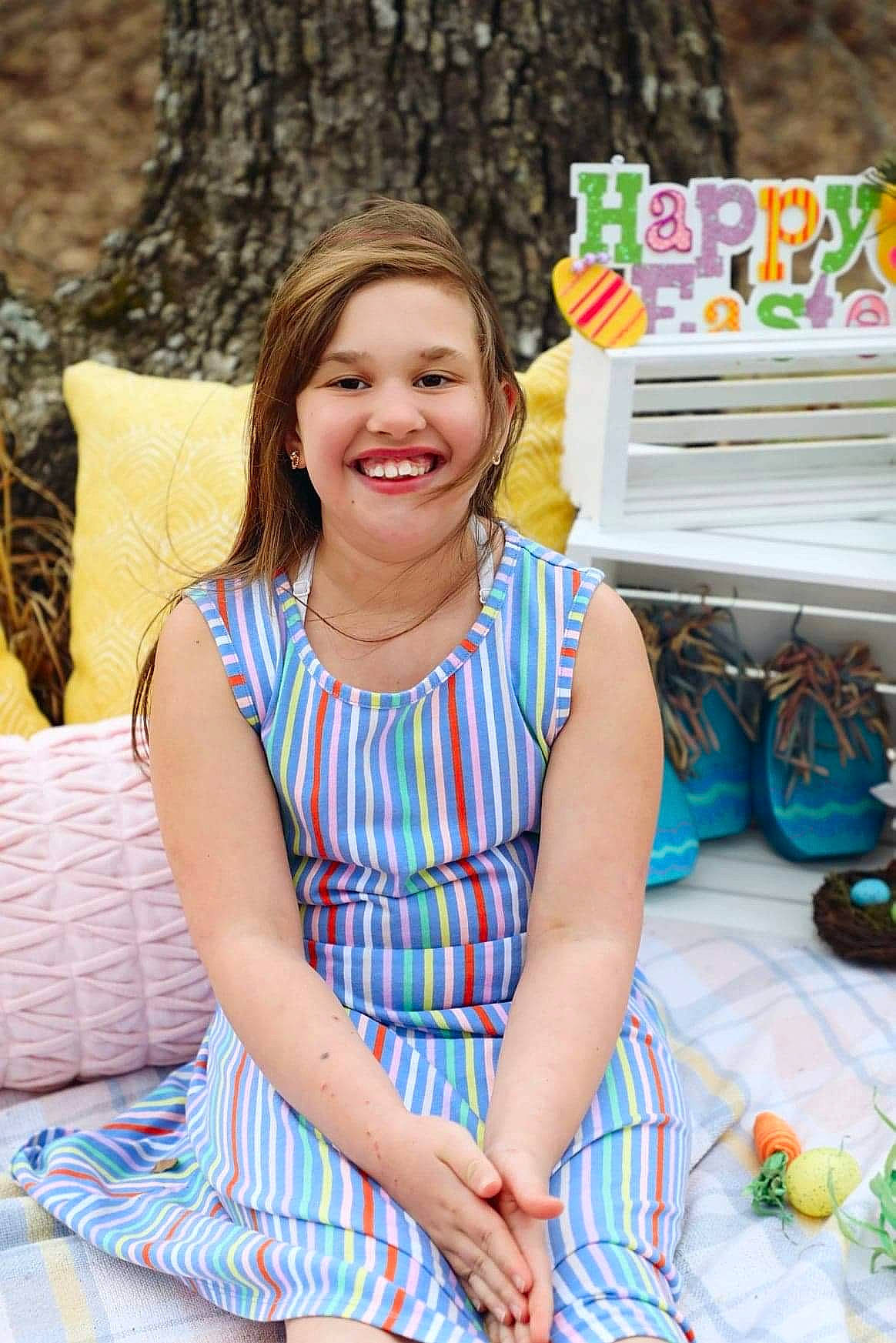 Andrea joined the competition — help win amazing prizes! child, dress, electric_blue, event, fun, grass, green, happy, jewellery, joy, laugh, leisure, necklace, pattern, person, plant, recreation, sitting, smile, textile