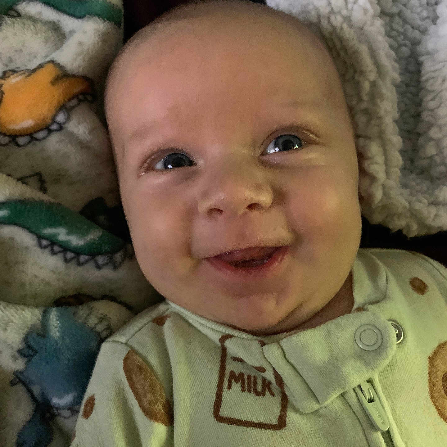 Augustine is registered to the contest to win money with this photo: baby, blanket, child, closeup, clothing, cozy, cute, expression, face, happy, head, indoor, infant, milk_carton, pajamas, person, portrait, skin, smiling, young