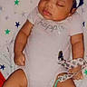 Keore is registered to the contest to win money with this photo: baby, sleeping, onesie, headband, bow, blanket, star_pattern, infant, peaceful, cute, child, toddler, resting, indoors, soft, skin, small, adorable, relaxed, laying_down