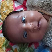 Taqdeer Kaur joined the competition — help win amazing prizes! baby, infant, face, portrait, closeup, fuzzy_clothing, blanket, colorful, pattern, child, newborn, skin, head, cute, lying_down, indoors, soft_texture, young, expression, warm