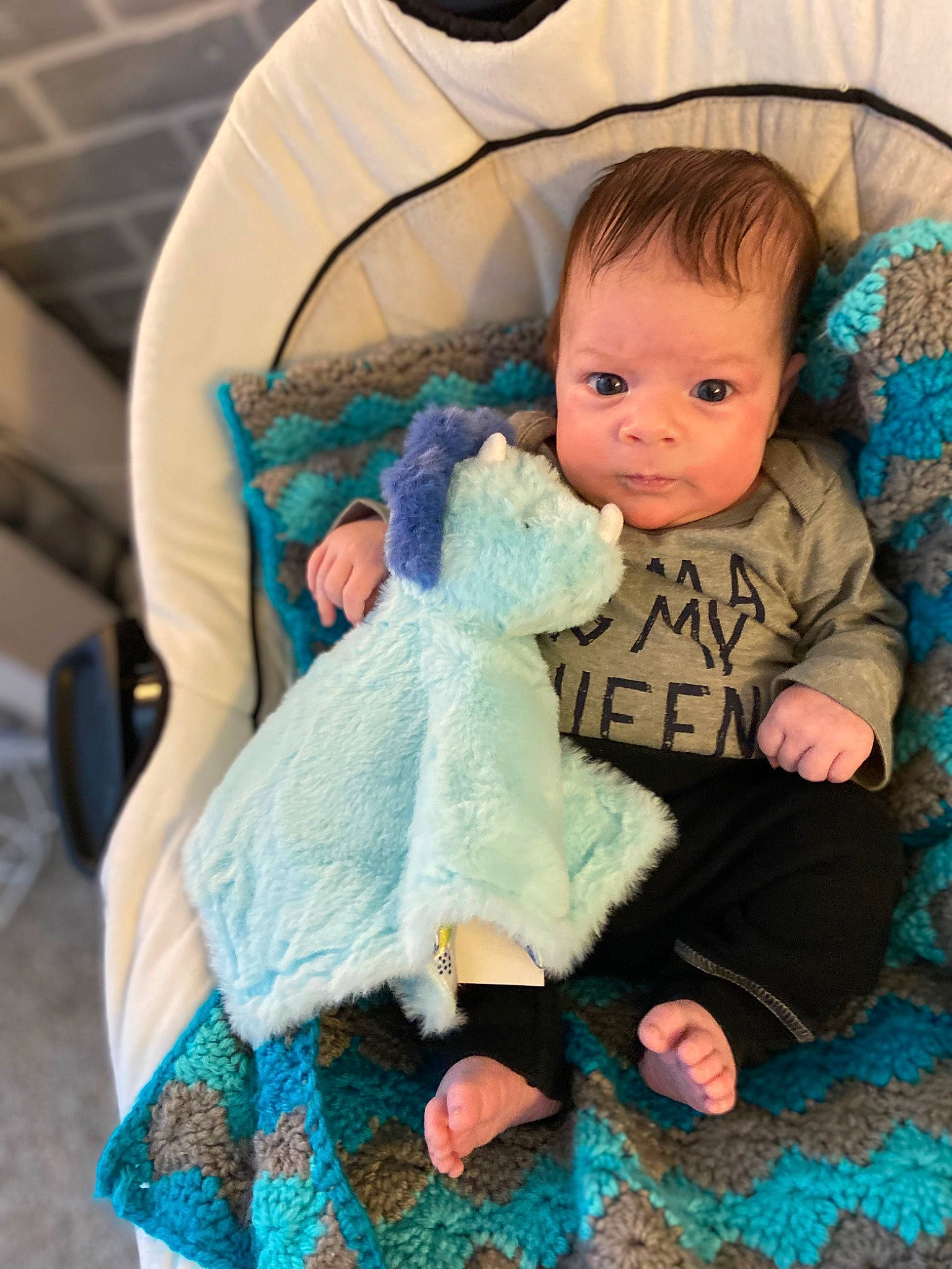 Miles is registered to the contest to win money with this photo: aqua, baby, baby_carriage, baby_products, baby_toddler_clothing, blue, chair, cheek, comfort, eye, headgear, human_body, infant_bed, iris, lap, person, sitting, skin, sleeve, sock