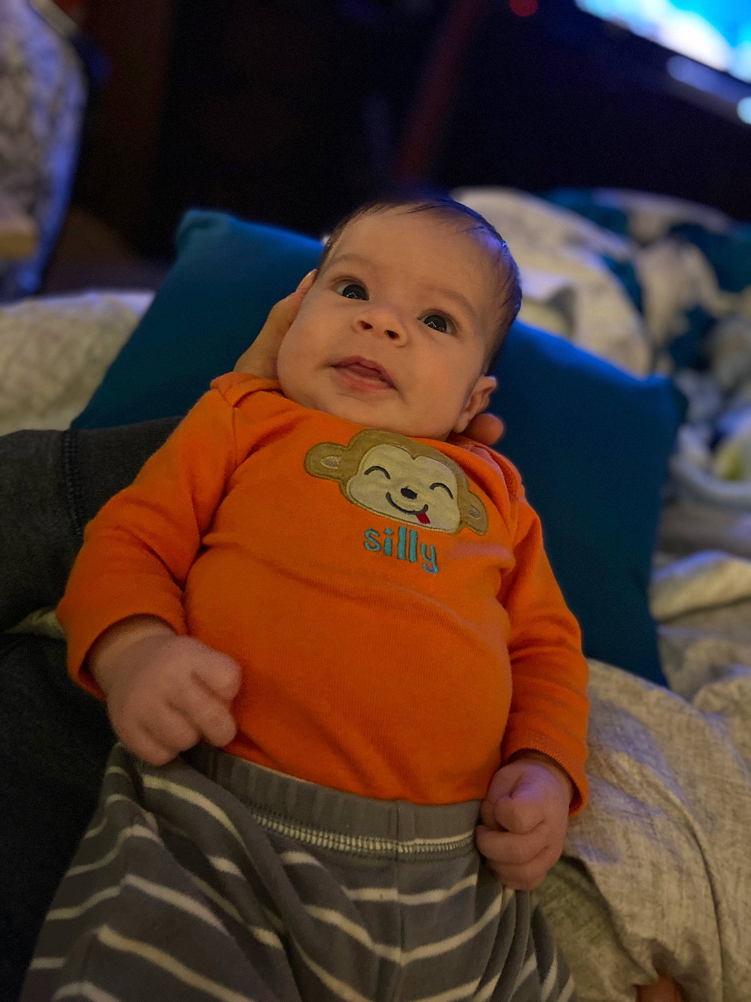 Miles is registered to the contest to win money with this photo: baby, baby_toddler_clothing, cheek, child, chin, comfort, couch, eye, fun, happy, head, human_body, iris, mouth, nose, orange, person, skin, sleeve, smile