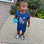 Ayden is registered to the contest to win money with this photo: child, toddler, smiling, blue_clothing, shorts, tshirt, sippy_cup, sidewalk, flowers, greenery, outdoor, shoes, happy, person, cute, daylight, nature, plants, hair, playful