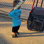 Ayden joined the competition — help win amazing prizes! child, baseball_bat, sports_bag, baseball_field, chain_link_fence, sports_jersey, outdoor, sunlight, shadow, player, grass, dirt, athlete, team, game, spectator, shoes, shorts, recreation, park