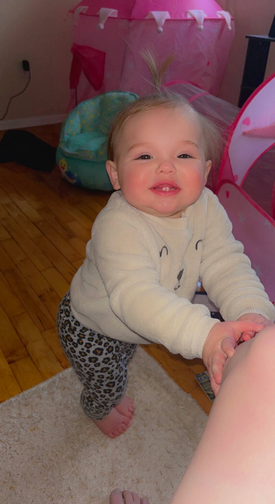 Journey is registered to the contest to win money with this photo: baby, baby_toddler_clothing, cheek, child, comfort, eye, floor, flooring, fun, hardwood, human_body, iris, mouth, nose, person, sitting, skin, sleeve, smile, toddler