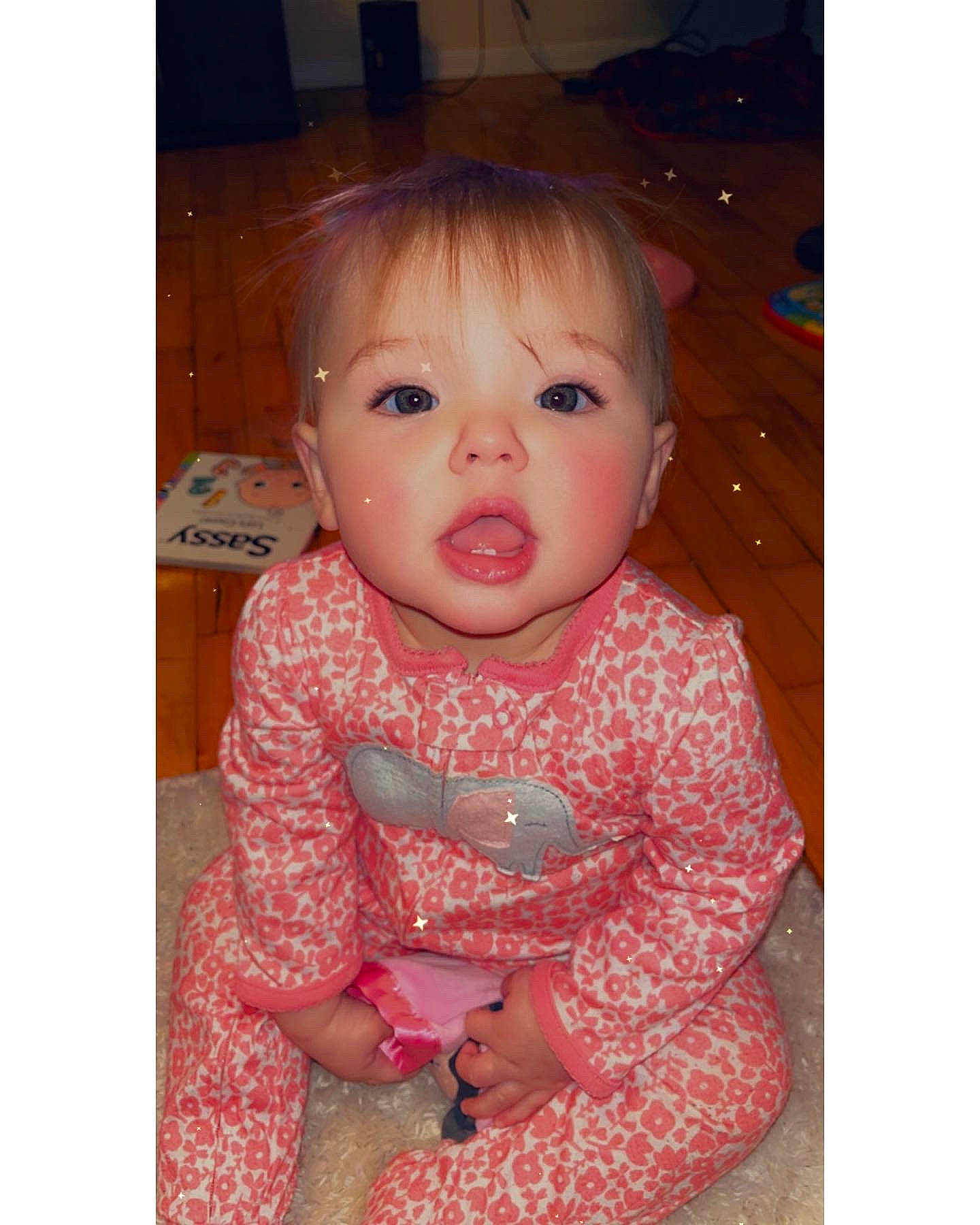 Journey is registered to the contest to win money with this photo: baby, baby_toddler_clothing, bangs, brown_hair, cheek, child, dress, ear, eye, eyebrow, eyelash, face, finger, gesture, happy, iris, lip, nose, person, sleeve