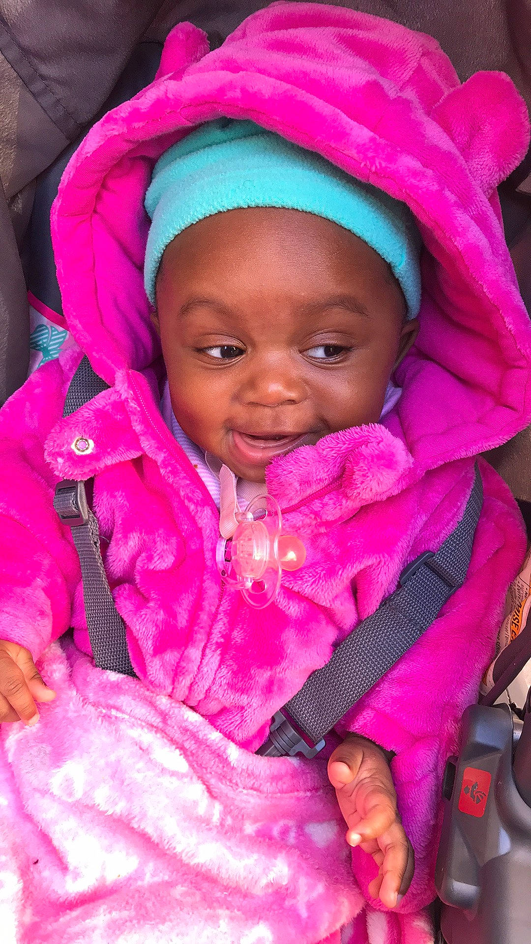 Adora is registered to the contest to win money with this photo: baby, cheek, child, eye, face, head, headgear, lip, magenta, person, pink, skin, smile, toddler