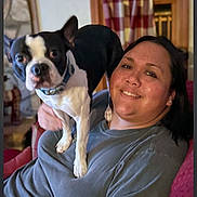 Butch is registered to the contest to win money with this photo: animal, boston_terrier, casual_clothing, companion, couch, cozy, curtains, dog, friendly, furniture, happy, home, indoor, person, pet, portrait, relaxing, smile, window, woman