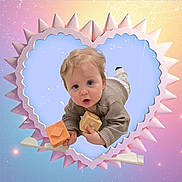 Elio participe au concours pour gagner de l'argent avec cette photo : baby, blond_hair, blue_eyes, child, close_up, crawling, curious_expression, cute_face, decorative_border, heart_frame, infant, onesie, pastel_background, playful, portrait, props, soft_lighting, studio_graphic, toddler, toy_block