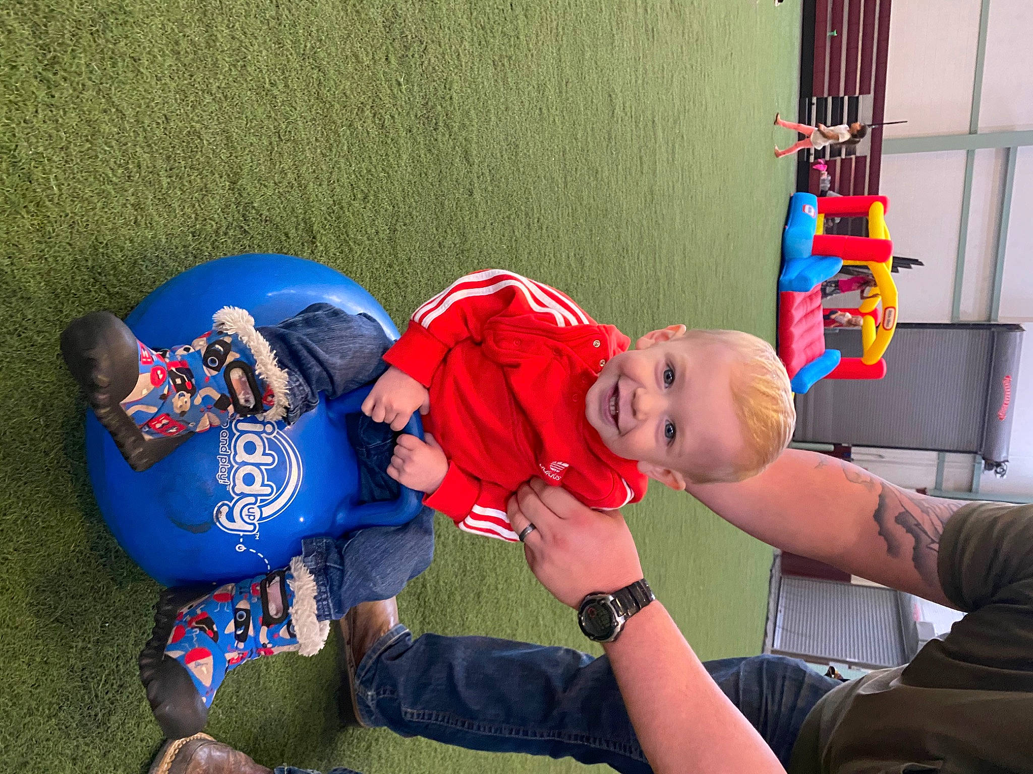 Brody is registered to the contest to win money with this photo: baby, baby_toddler_clothing, child, electric_blue, fun, grass, happy, joy, knee, leisure, person, play, player, recreation, shorts, sitting, t_shirt, team, team_sport, thigh