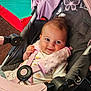 baby, stroller, child, infant, smile, harness, pink, black, butterfly, playground, seat, clothing, happy, person, cute, childcare, resting, indoor, toy, comfort