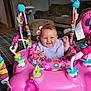 baby, smiling, pink, jumper, toy, minnie_mouse, indoor, carpet, couch, living_room, child, happy, clothing, colorful, floor, person, playtime, furniture, infant, seat