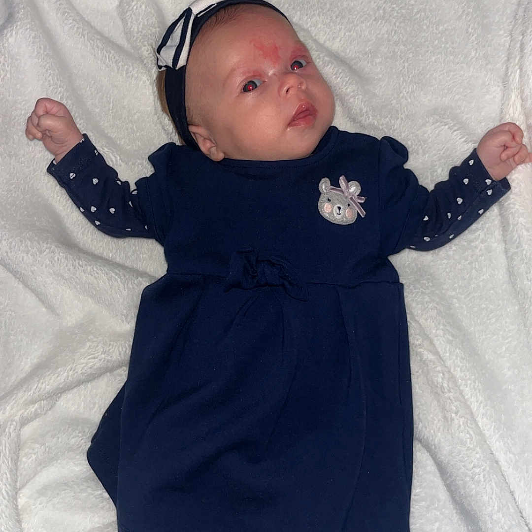 Alyanna participe au concours pour gagner de l'argent avec cette photo : adorable, baby, blanket, child, clothing, cute, dress, fabric, face, gray_socks, headband, indoor, infant, lying_down, person, portrait, resting, small, soft_texture, young