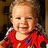 toddler, child, smiling, curly_hair, blue_eyes, red_shirt, mickey_mouse, high_chair, indoor, portrait, happy, cute, baby, person, clothing, face, expression, seated, warm_lighting, home