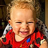 Jermaine is registered to the contest to win money with this photo: toddler, child, smiling, curly_hair, red_shirt, mickey_mouse, high_chair, indoor, portrait, happy, baby, cute, face, person, clothing, seat, expression, light, background, star_pattern