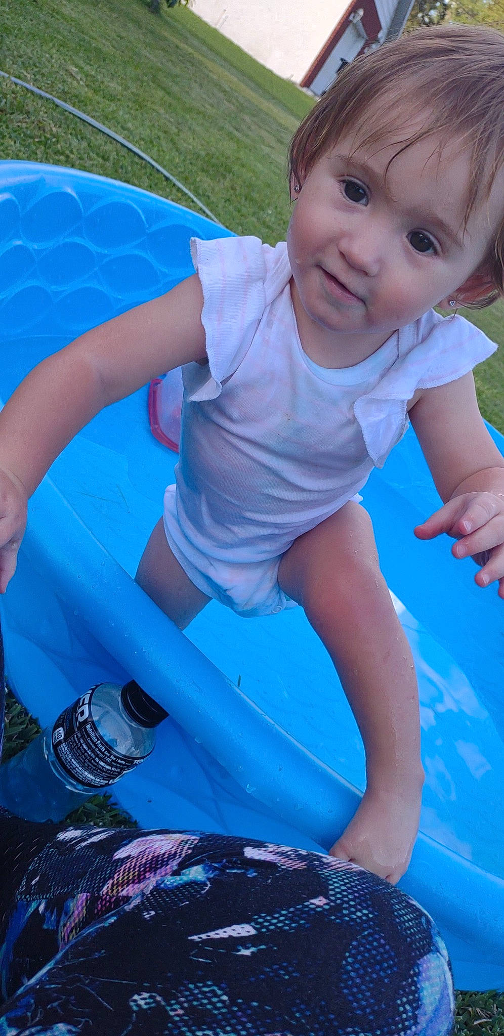 Daisy is registered to the contest to win money with this photo: aqua, baby_toddler_clothing, blue, child, electric_blue, eye, fun, grass, happy, human_leg, leisure, outdoor_play_equipment, person, pink, playground, recreation, smile, summer, thigh, toddler