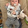 Nolann a rejoint le concours — aidez-le/la à gagner de superbes lots ! baby, pacifier, bib, plush_toy, bunny, toy, padded_surface, grey_pants, socks, infant, cute, child, indoor, lying_down, cozy, comfortable, soft, adorable, person, young_child
