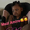 toddler, child, car_seat, seatbelt, indoor, looking_away, black_hair, braids, expression, thinking, skin, hand, foot, text_overlay, emoji, casual, portrait, young_child, seat, sitting