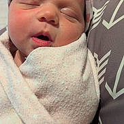 Hazely joined the competition — help win amazing prizes! newborn, baby, infant, sleeping, portrait, face, swaddled, blanket, hat, headband, cozy, indoor, close_up, baby_clothing, soft_lighting, cushion, resting, peaceful, family_photo, cute