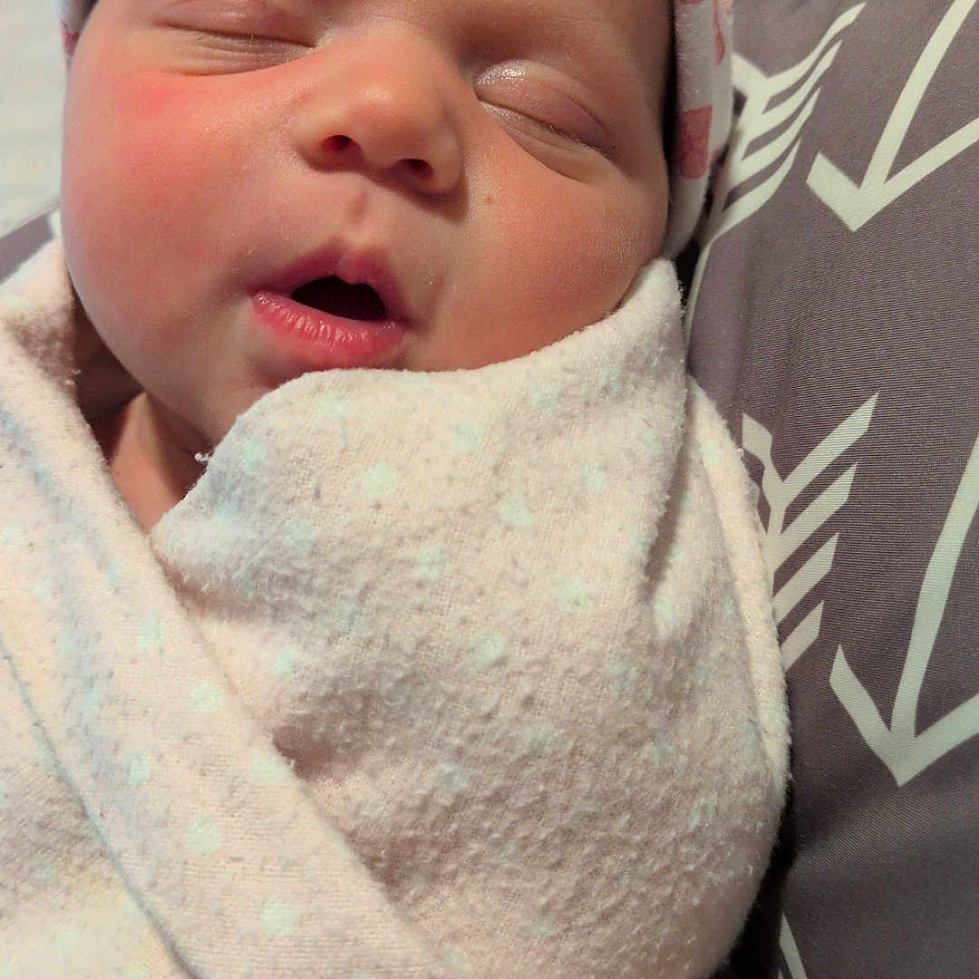 Hazely joined the competition — help win amazing prizes! newborn, baby, infant, sleeping, portrait, face, swaddled, blanket, hat, headband, cozy, indoor, close_up, baby_clothing, soft_lighting, cushion, resting, peaceful, family_photo, cute
