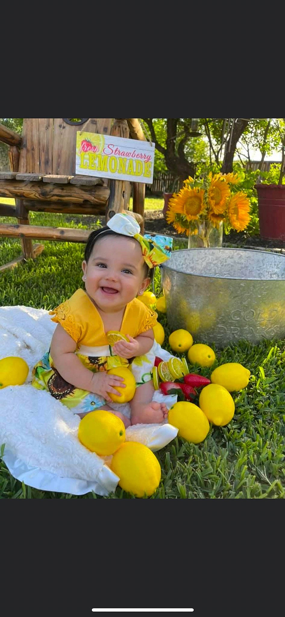 Amiyah is registered to the contest to win money with this photo: baby, baby_toddler_clothing, balloon, child, event, flower, flowerpot, fun, garden, grass, happy, headwear, joy, leisure, people_in_nature, person, plant, recreation, smile, toddler