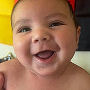 Luca joined the competition — help win amazing prizes! baby, smiling, happy, face, portrait, child, closeup, skin, human, expression, colorful_background, flag, red, yellow, black, eyes, mouth, cheeks, infant, joy