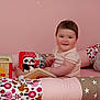 baby, child, colorful, cozy, cushion, cute, decor, face, happy, indoor, infant, pajamas, person, pink, playtime, smiling, soft, star_pattern, toy, wooden_toy