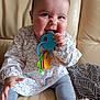 Ninon participe au concours pour gagner de l'argent avec cette photo : baby, blanket, chewing, child, clothing, couch, cute, face, foot, hand, happy, indoor, leather, leggings, long_sleeve, pattern, person, sitting, smiling, teething_toy