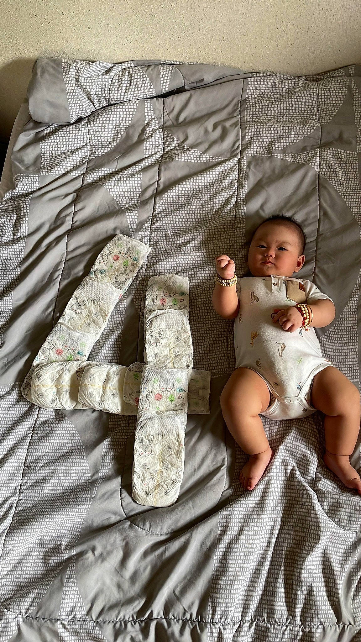 Kenny is registered to the contest to win money with this photo: baby, baby_toddler_clothing, bedding, child, comfort, flash_photography, flooring, foot, grey, human_leg, linens, pattern, person, product, sitting, sleeve, t_shirt, textile, thigh, toddler