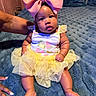 Ava-Rose is registered to the contest to win money with this photo: baby, child, pink_bow, yellow_tutu, blue_blanket, cute, infant, sitting, hands, plush, soft_texture, indoors, portrait, clothing, toddler, expression, face, skin, legs, feet