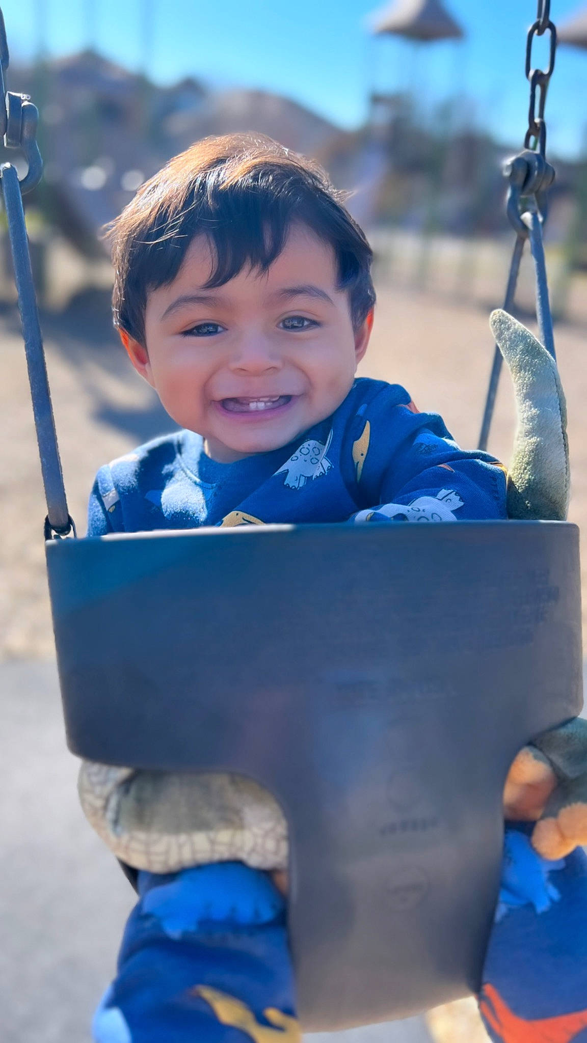 Gabriel joined the competition — help win amazing prizes! azure, blue, child, cool, eye, facial_expression, fun, gesture, happy, human, joy, leisure, person, public_space, recreation, sky, sleeve, smile, standing, swing