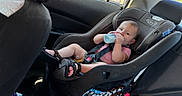 Carson is registered to the contest to win money with this photo: baby, bottle, car_interior, car_seat, casual, child, child_safety, cute, daylight, infant, pacifier, person, relaxing, sandals, seat, seatbelt, sitting, sunlight, vehicle, window