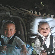 Twins joined the competition — help win amazing prizes! baby, car_seat, smiling, blanket, child, infant, seatbelt, indoors, toddler, clothing, person, cute, happy, face, sitting, two_children, carrying_device, people, baby_boy, baby_girl