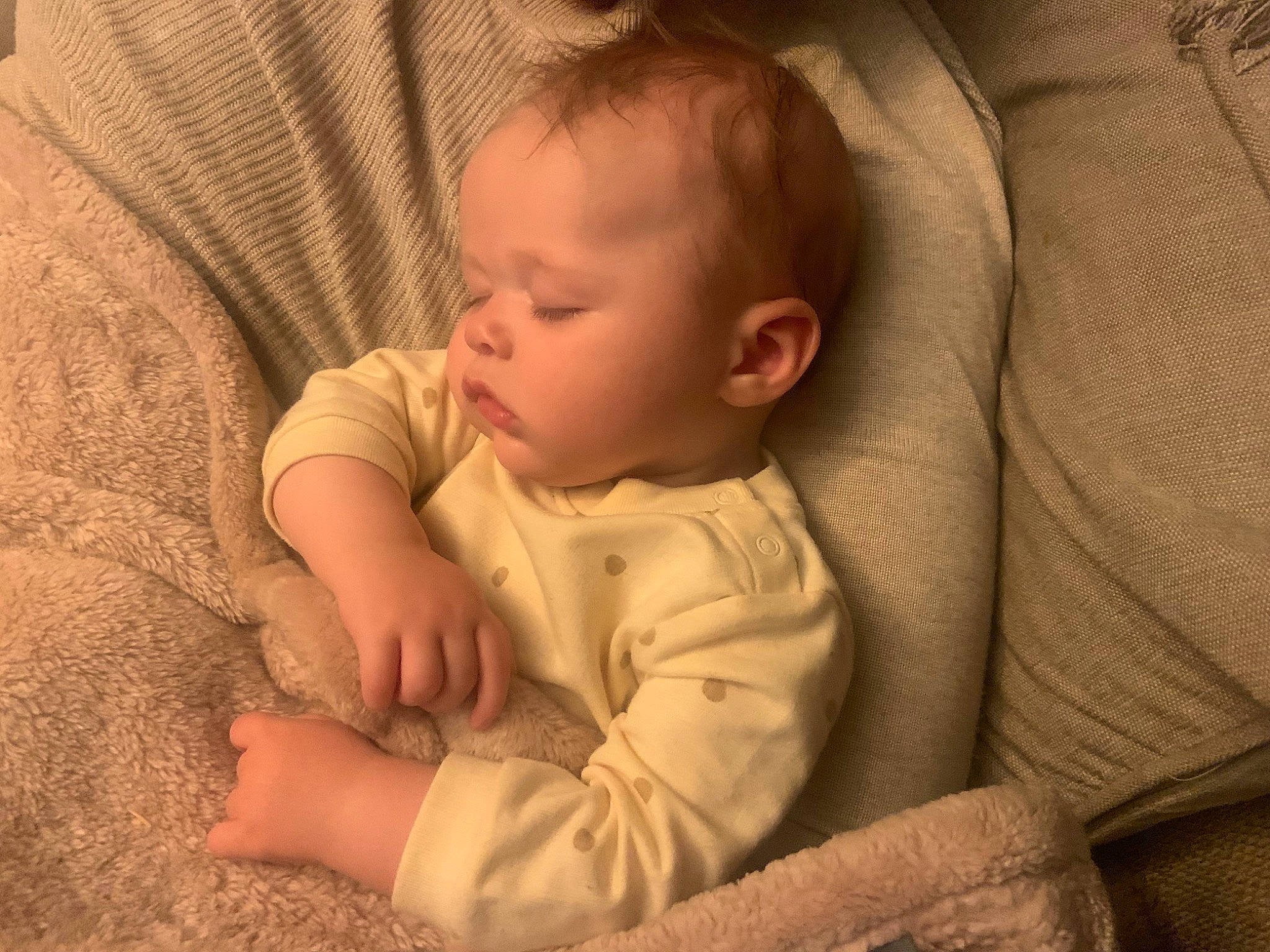 Charlotte is registered to the contest to win money with this photo: baby, baby_toddler_clothing, cheek, child, chin, comfort, eye, facial_expression, flooring, hairstyle, iris, linens, mouth, nose, person, room, sitting, skin, sleeve, toddler