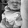 baby, sleeping, infant, blanket, cozy, soft, monochrome, black_and_white, face, peaceful, cute, portrait, child, indoors, closeup, resting, newborn, warm, toddler, comfort