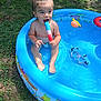 blue, child, colorful, fun, goggles, grass, happy, inflatable, outdoor, playing, pool, popsicle, sitting, skin, summer, sunlight, toddler, toy, water, wet