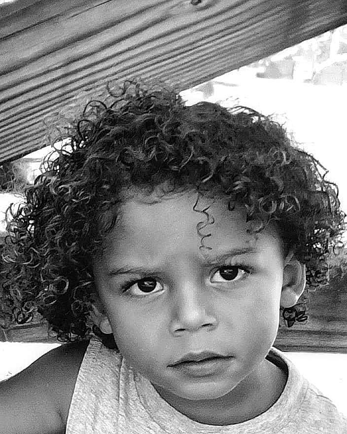 Eli is registered to the contest to win money with this photo: afro, black, black_and_white, black_hair, cheek, chin, eye, eyebrow, facial_expression, forehead, hair, hairstyle, happy, head, jheri_curl, lip, nose, person, ringlet, style