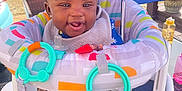 Kaija is registered to the contest to win money with this photo: baby, smiling, happy, infant, baby_seat, toys, umbrella, outdoor, colorful, playful, child, sunny_day, clothing, pacifier, rainbow_toy, plastic_toys, face, person, seat, cute