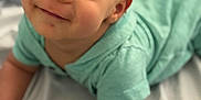 Joseph joined the competition — help win amazing prizes! baby, child, smiling, tummy, mint_green_clothing, face, skin, eyes, portrait, infant, cute, lying_down, soft_light, close_up, baby_hands, expression, indoors, fabric, blanket, happy