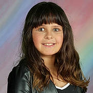 Justine is registered to the contest to win money with this photo: child, girl, smiling, portrait, long_hair, bangs, leather_jacket, black_clothing, pastel_background, studio_photo, happy, face, young, casual_wear, fashion, person, hair, eyes, indoor, colorful_background