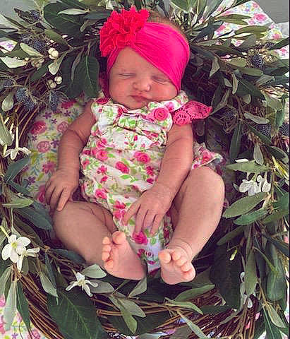 Breonna joined the competition — help win amazing prizes! baby, baby_toddler_clothing, cap, eye, finger, grass, green, happy, headwear, human_body, leaf, mammal, organ, people_in_nature, person, pink, plant, purple, skin, textile