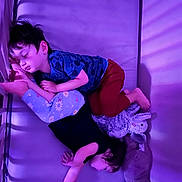 Jaxson joined the competition — help win amazing prizes! bed, bodypart, boy, child, clothing, couch, crib, face, finger, furniture, hand, head, infantbed, male, pants, person, photography, portrait, purple, shorts