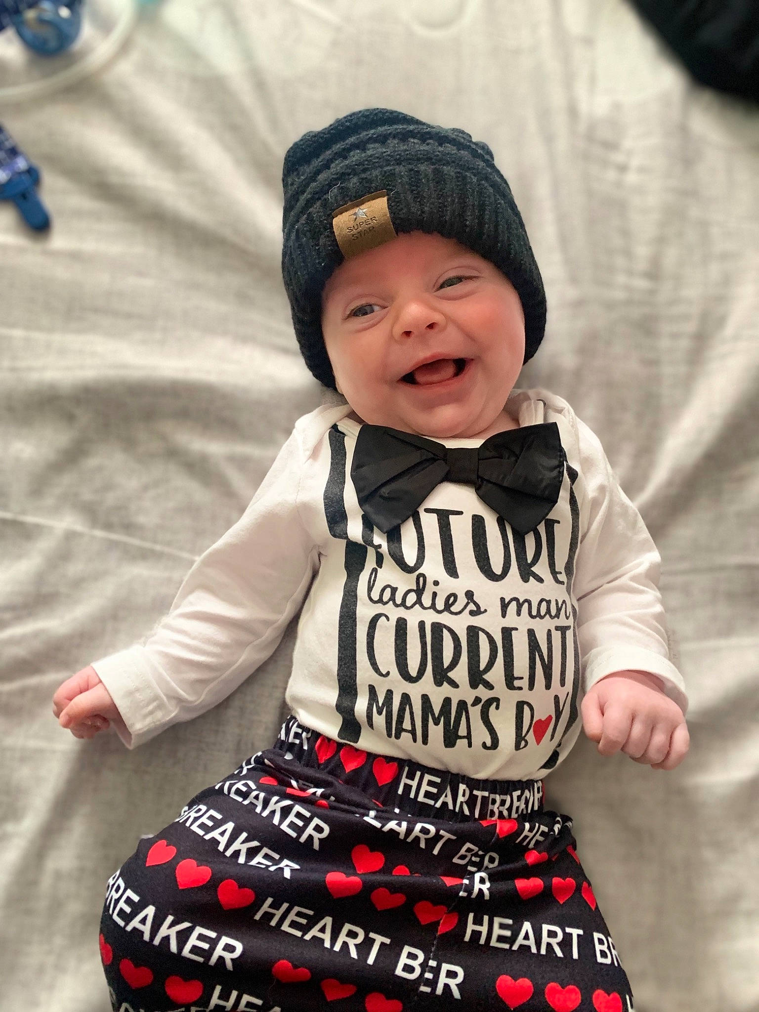 Landon is registered to the contest to win money with this photo: arm, baby, baby_toddler_clothing, cap, child, cool, face, fashion, font, happy, headwear, jacket, pattern, person, pink, product, sleeve, smile, t_shirt, textile