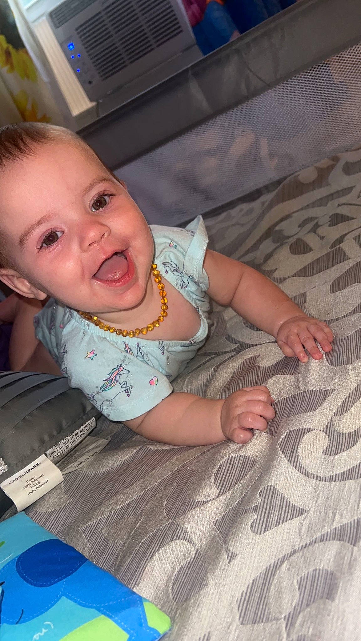 Journey is registered to the contest to win money with this photo: baby, baby_products, baby_toddler_clothing, cheek, child, comfort, finger, flooring, fun, hand, iris, linens, mammal, person, product, room, sitting, skin, smile, toddler
