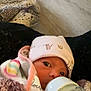 Ellie is registered to the contest to win money with this photo: baby, bottle, feeding, blanket, hat, infant, closeup, face, indoors, child, newborn, cozy, warm, sleepy, person, cute, soft, resting, wearing, comfort