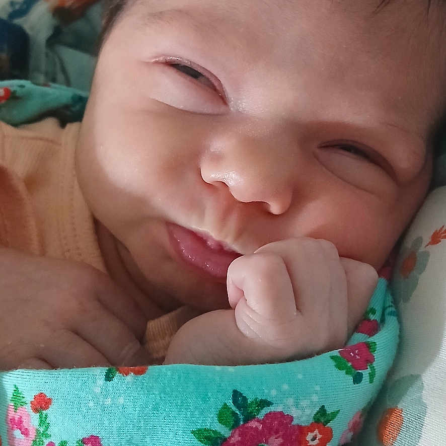 Dana joined the competition — help win amazing prizes! baby, blanket, closeup, clothing, cozy, cute, expression, face, floral, hand, indoors, infant, newborn, person, portrait, resting, skin, sleepy, soft, young