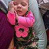 baby, sleeping, infant, camo_clothing, pink, flower_pattern, pillow, blanket, hand, cozy, resting, child, person, cute, soft_texture, indoor, portrait, peaceful, toddler, closeup
